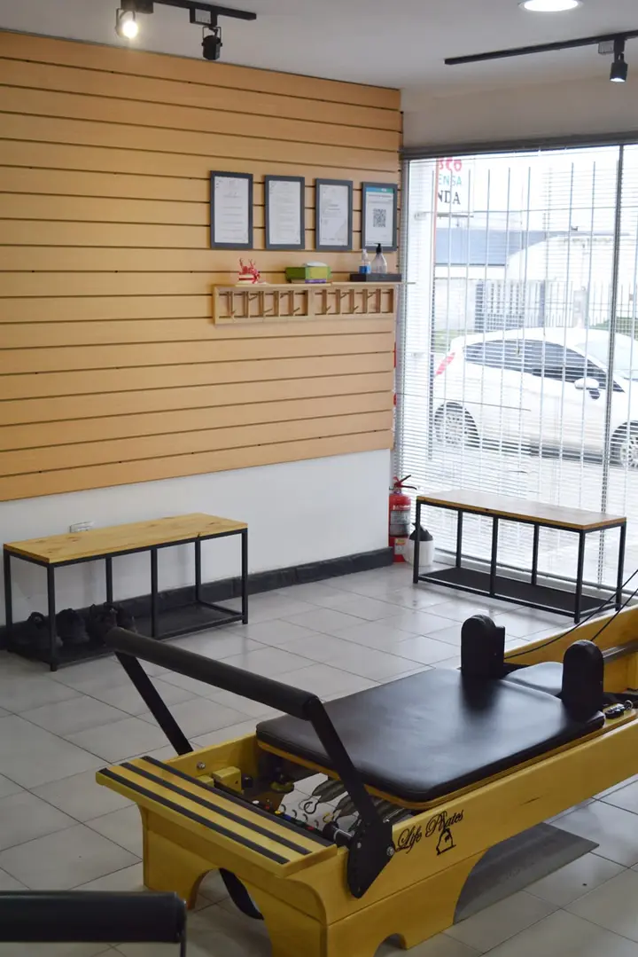 Una cama reformer de Metanoia Pilates junto a la ventana del estudio